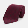 View 1 of product The HOUNDSTOOTH NAVY BURGUNDY TIE by Turnbull & Asser features a textured navy and burgundy silk woven pattern—an elegant staple for every gentleman’s wardrobe.