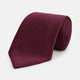 The HOUNDSTOOTH NAVY BURGUNDY TIE by Turnbull & Asser features a textured navy and burgundy silk woven pattern—an elegant staple for every gentleman’s wardrobe.