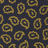 View 4 of product The Navy and Gold Petal Paisley Silk Tie by Turnbull & Asser features a repeating yellow abstract pattern, neatly rolled on a white background.