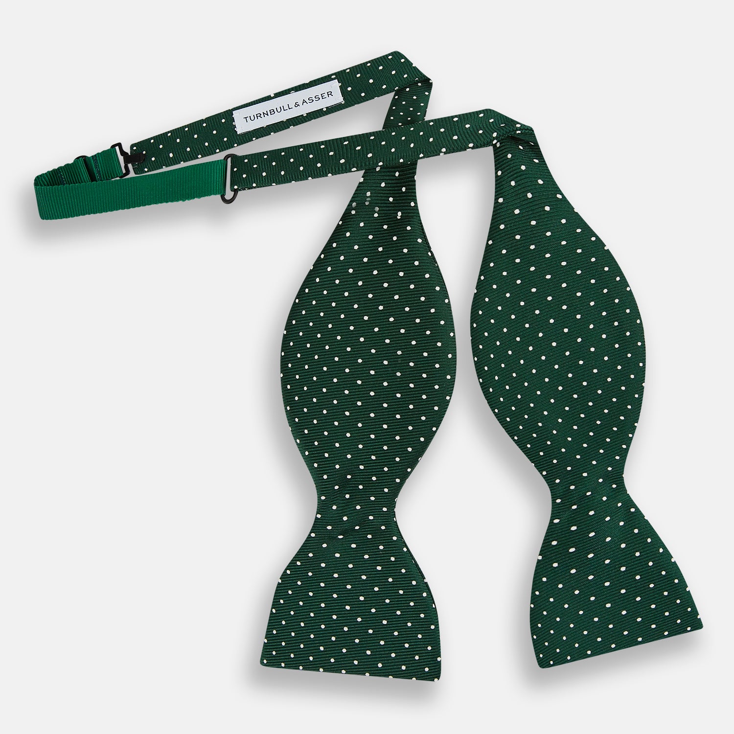 View 2 of product The Turnbull & Asser Racing Green and White Spot Silk Bow Tie features small white polka dots on luxurious silk, shown against a plain white background.