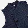 View 2 of product The Turnbull & Asser Navy Double-Breasted Quilted Gilet is a sleeveless piece with an asymmetrical button closure, chest pocket, and two zippered side pockets, shown on a plain white background—ideal for layered dressing.