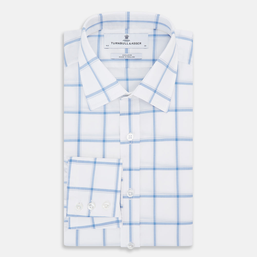 The Turnbull & Asser Colony Blue Grid Check Mayfair Shirt features long sleeves, a button-down front, Italian cotton fabric, a spread collar, and buttoned cuffs, shown against a plain white background.