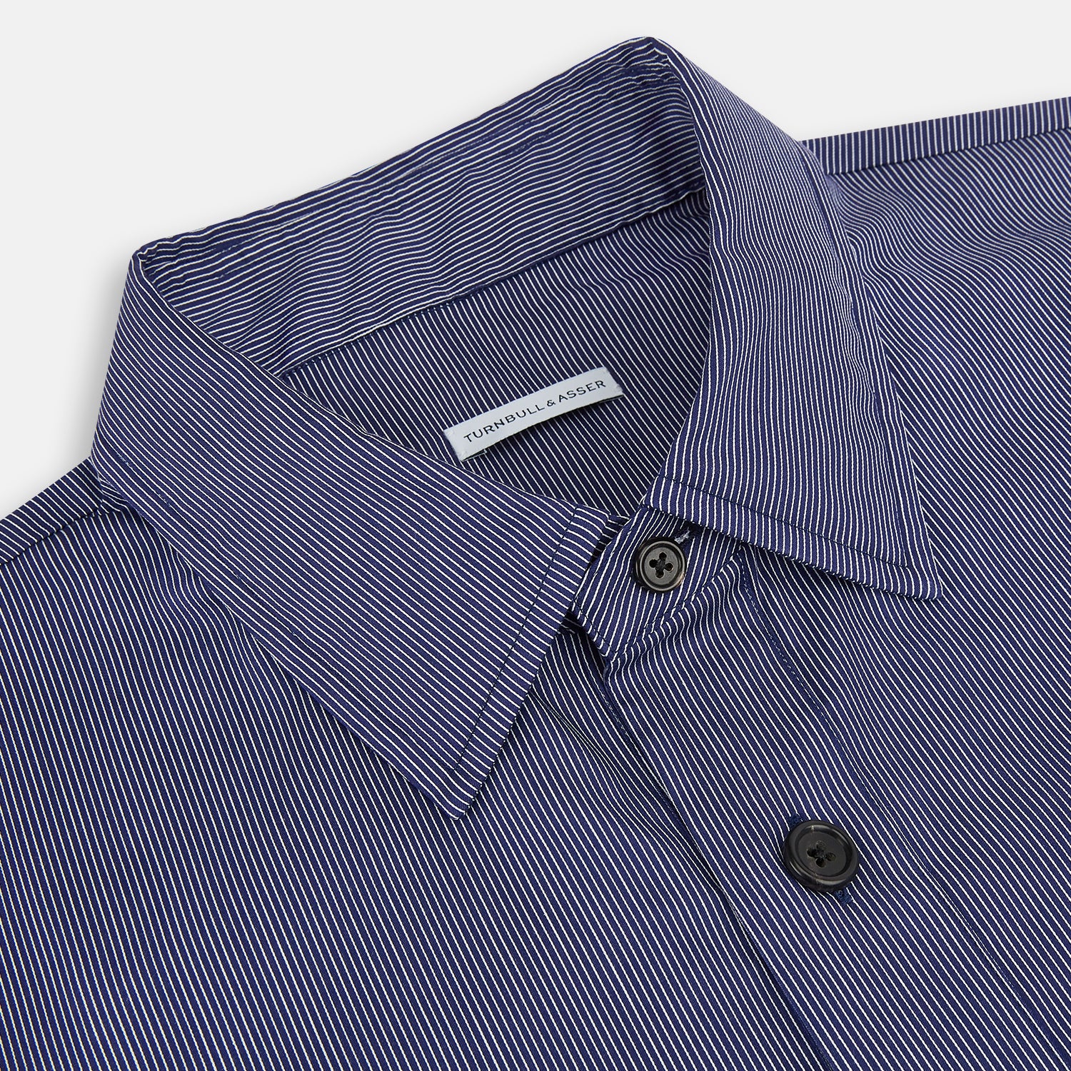 View 2 of product Turnbull & Asser’s Navy Stripe Highbury Overshirt with long sleeves, button-up front, black buttons, collar, and a left chest pocket is shown laid flat on a white background.