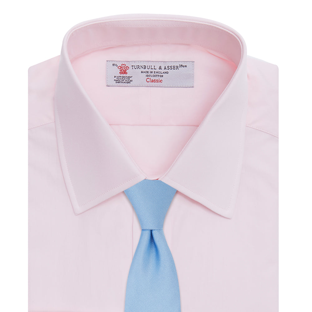 A Turnbull & Asser Pink Cotton Shirt with a T&A collar and double cuffs is displayed against a white background. The men's shirt features long sleeves, white buttons, and the label is visible inside the collar.
