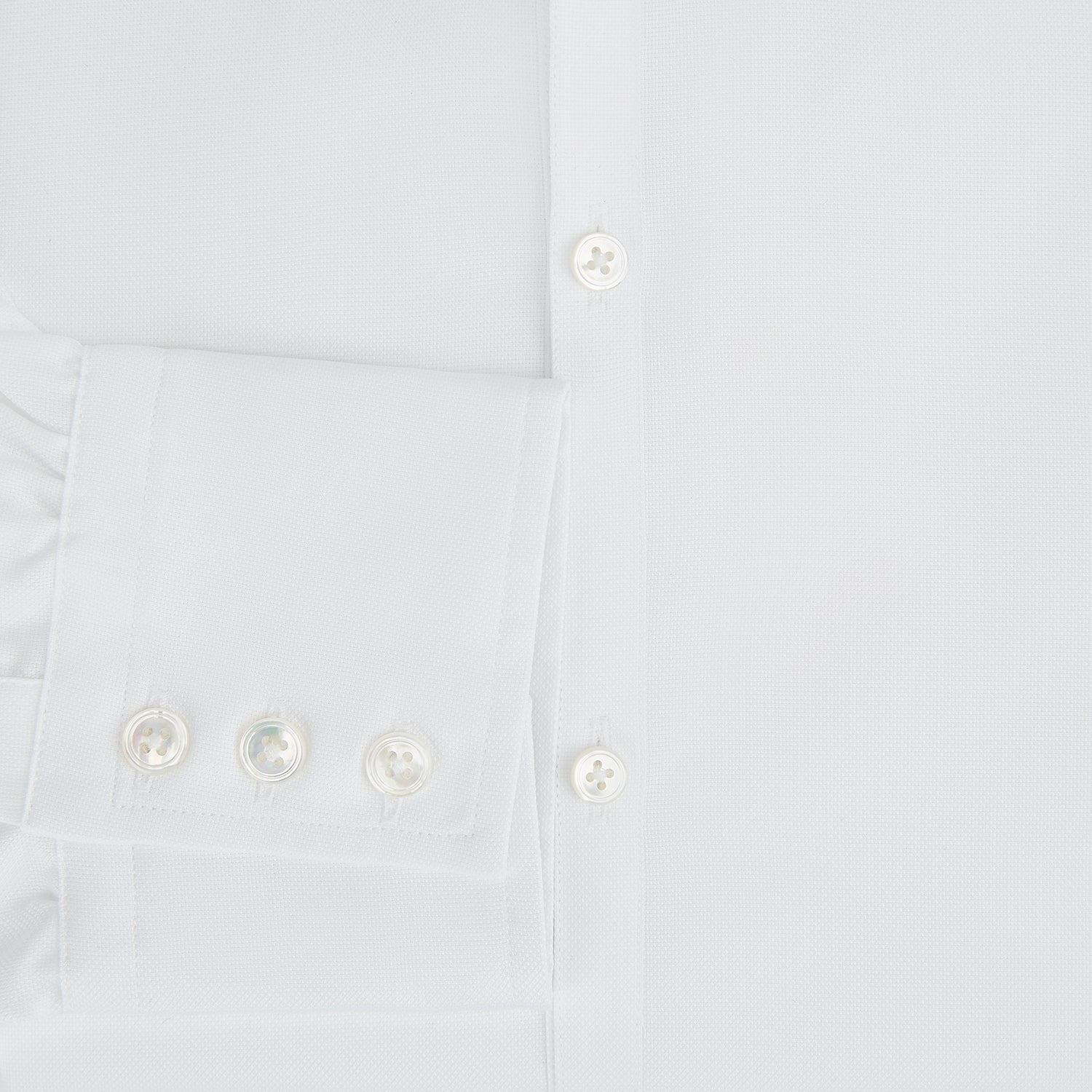 View 4 of product The Turnbull & Asser White Royal Oxford Cotton Windsor Shirt features a Turnbull open collar, long sleeves, 3-button cuffs, and a straight hem, shown against a plain white background.
