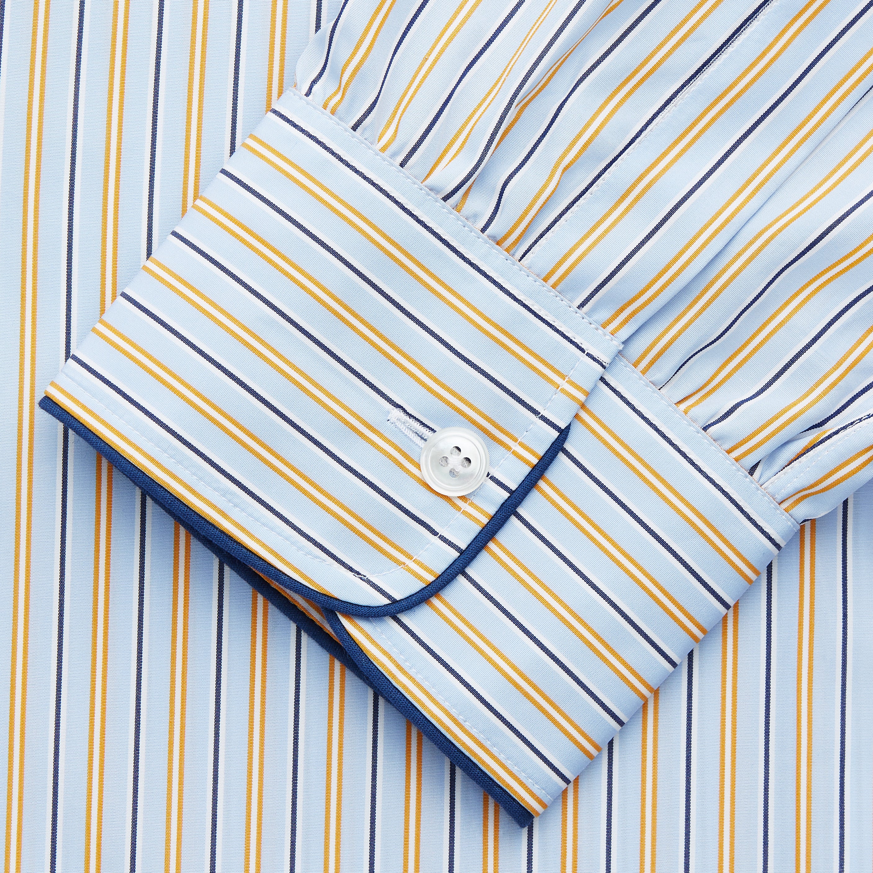 View 3 of product The Turnbull & Asser Blue, Orange and Navy Stripe Nightshirt is a loose-fitting shirt dress with vertical stripes, a pointed collar, chest pocket with blue trim, button-down front, long sleeves with cuffs, and a curved hem.