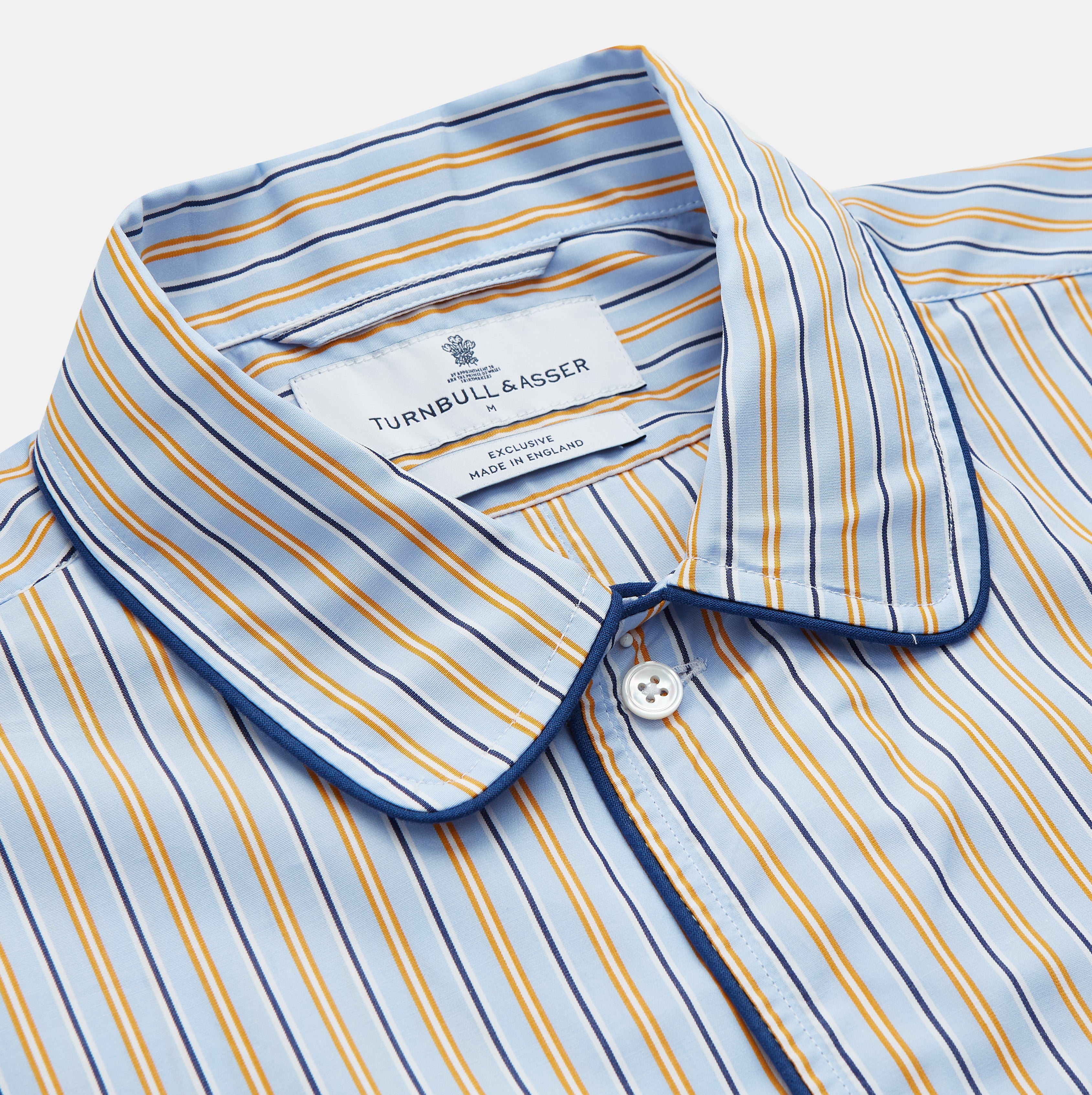 View 2 of product The Turnbull & Asser Blue, Orange and Navy Stripe Nightshirt is a loose-fitting shirt dress with vertical stripes, a pointed collar, chest pocket with blue trim, button-down front, long sleeves with cuffs, and a curved hem.