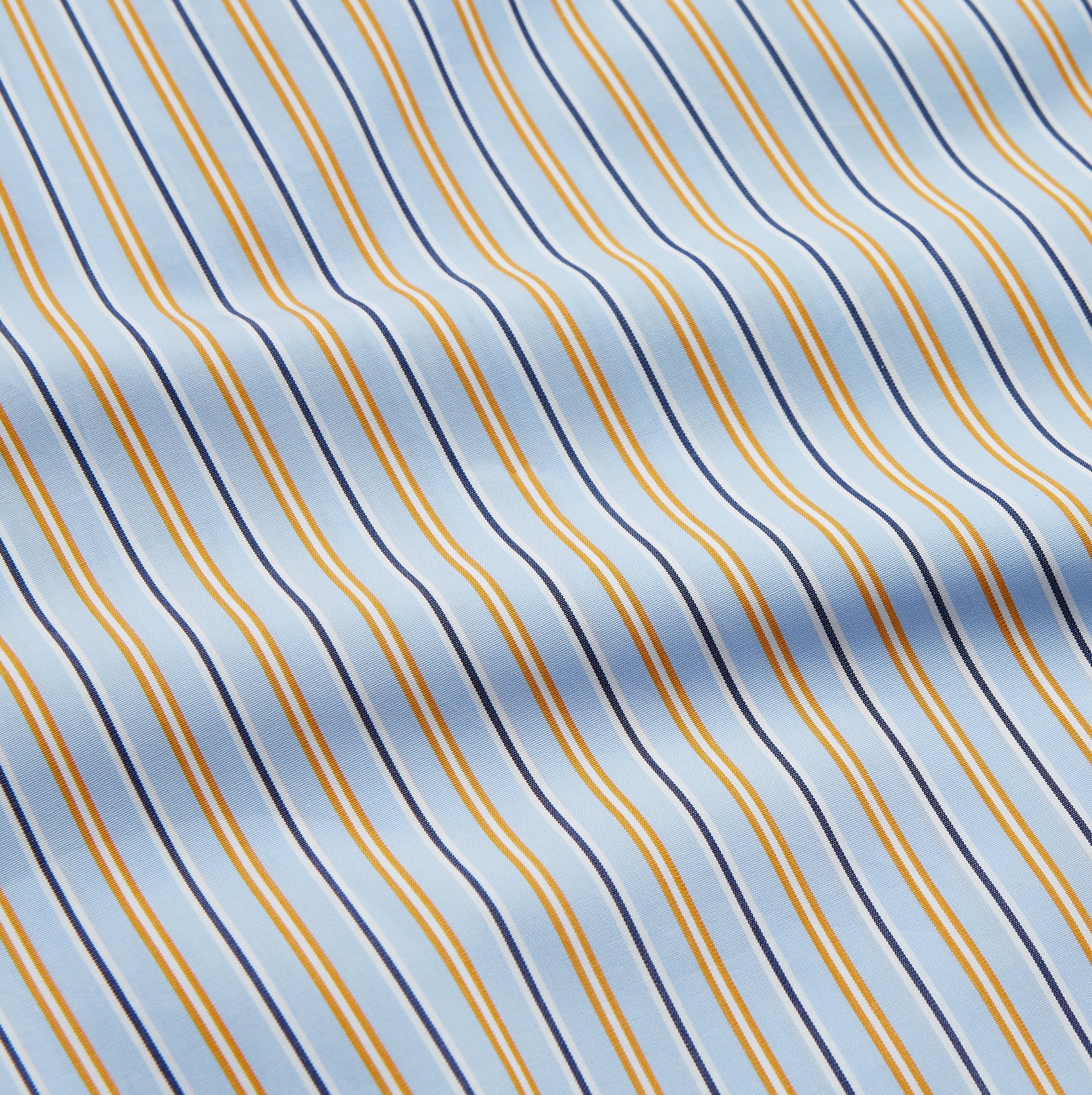 View 4 of product The Turnbull & Asser Blue, Orange and Navy Stripe Nightshirt is a loose-fitting shirt dress with vertical stripes, a pointed collar, chest pocket with blue trim, button-down front, long sleeves with cuffs, and a curved hem.