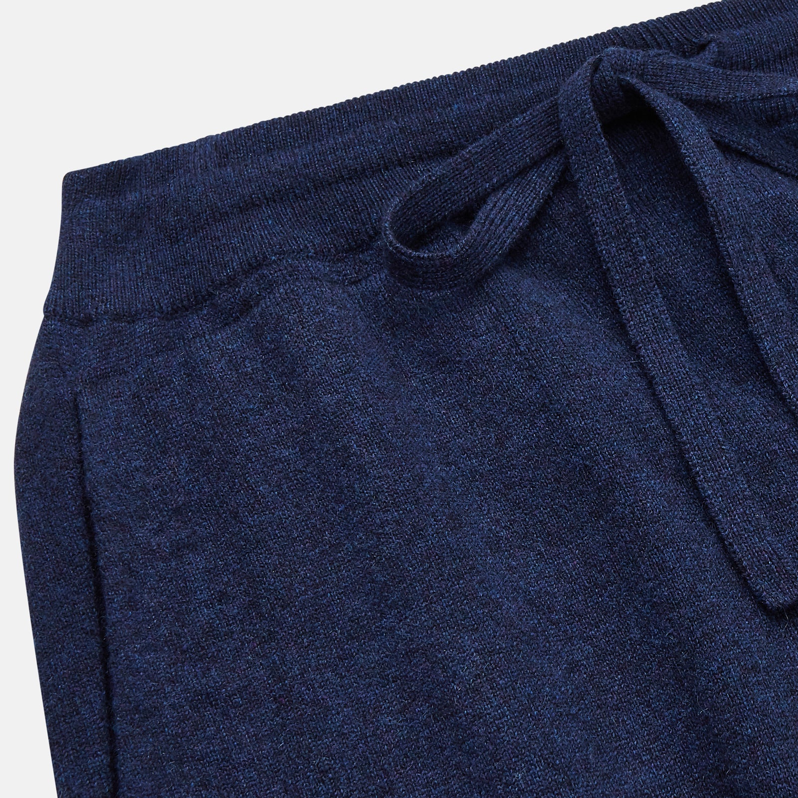 View 2 of product The Navy Cashmere Knitted Lounge Pyjama Trousers by Turnbull & Asser feature a contemporary fit, elastic waistband with drawstring, side pockets, and fitted cuffs, shown laid flat on a white background.