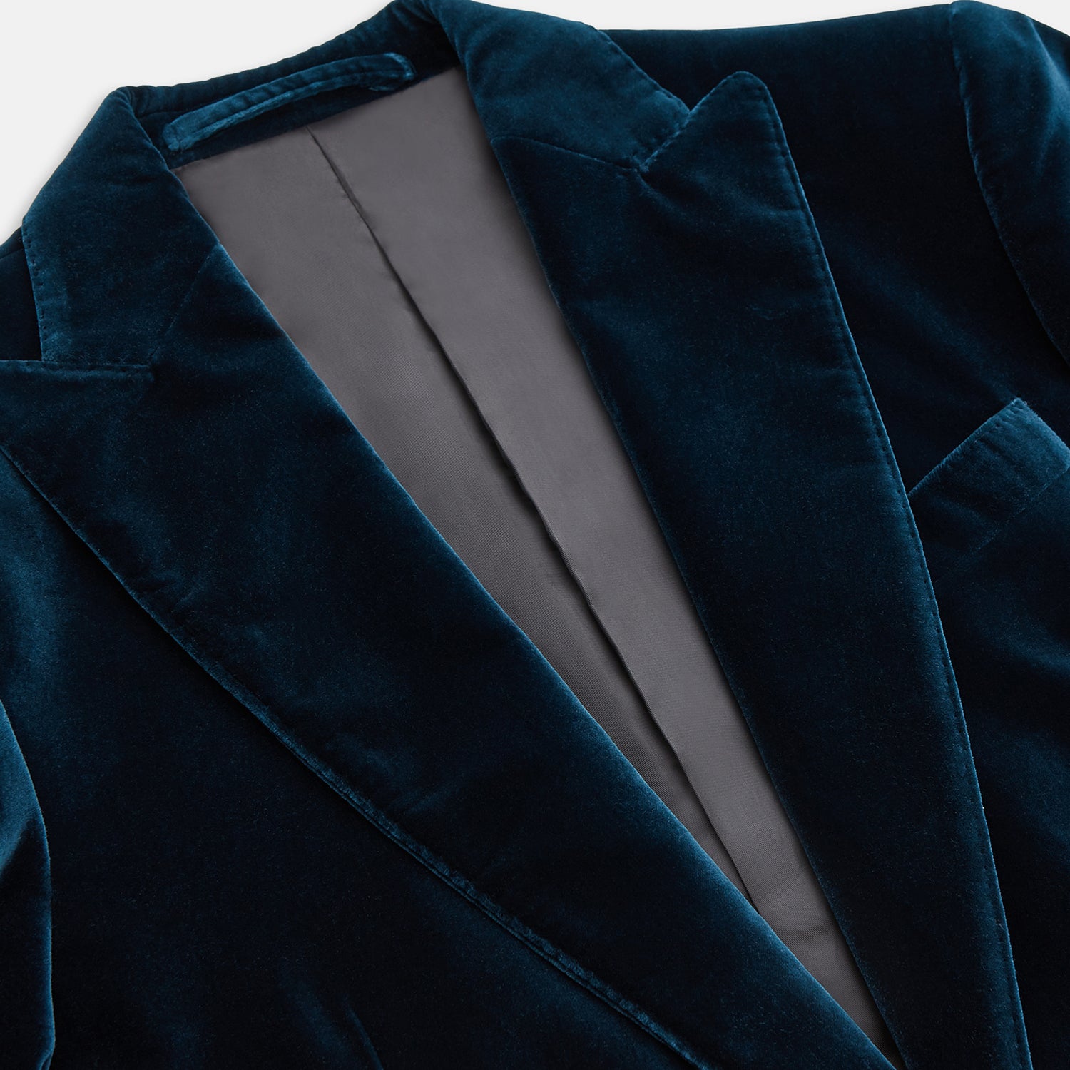 View 2 of product The Turnbull & Asser Teal Velvet Single Breasted Blazer features a single button closure, notched lapels, and front flap pockets, shown against a plain white background.