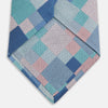 View 5 of product The Green Multi Pixel Silk Tie by Turnbull & Asser features a checked pattern in blue, teal, and pink on a light background, with diagonal stripes in each square for added texture.