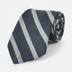 The Turnbull & Asser Blue & Silver Stripe Silk Tie, featuring wide diagonal stripes, is rolled up and displayed against a plain white background.