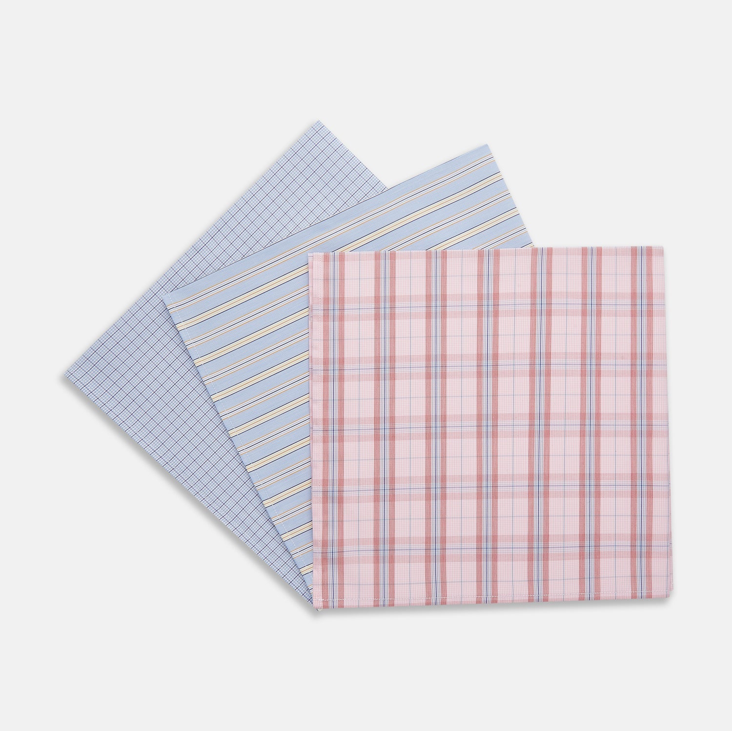 View 2 of product A set of three Turnbull & Asser Red and Blue Cotton RE-PURPOSE Handkerchiefs, neatly folded and tied with a blue and white striped ribbon, displayed against a white background.