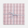 View 1 of product A set of three Turnbull & Asser Red and Blue Cotton RE-PURPOSE Handkerchiefs, neatly folded and tied with a blue and white striped ribbon, displayed against a white background.