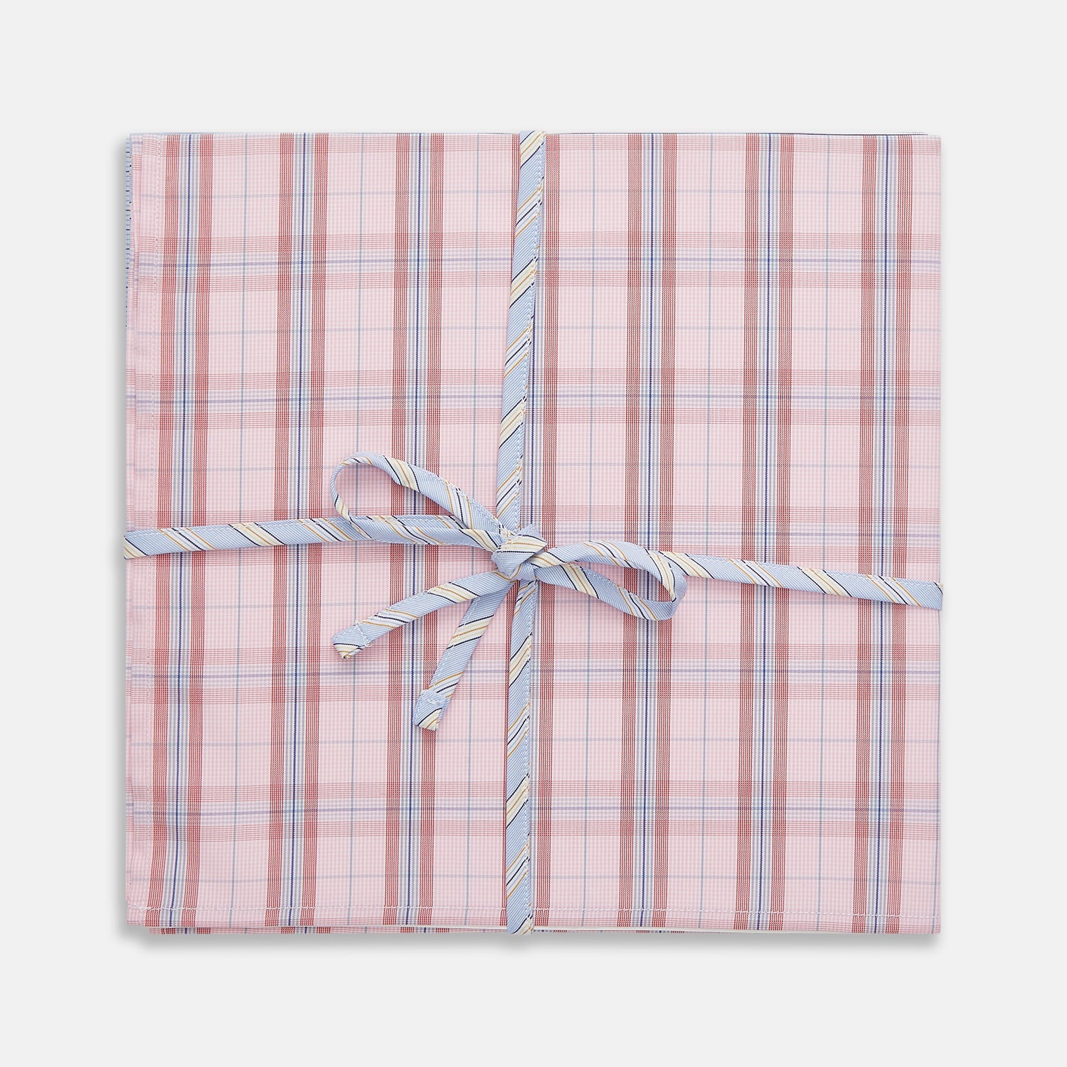 View 1 of product A set of three Turnbull & Asser Red and Blue Cotton RE-PURPOSE Handkerchiefs, neatly folded and tied with a blue and white striped ribbon, displayed against a white background.