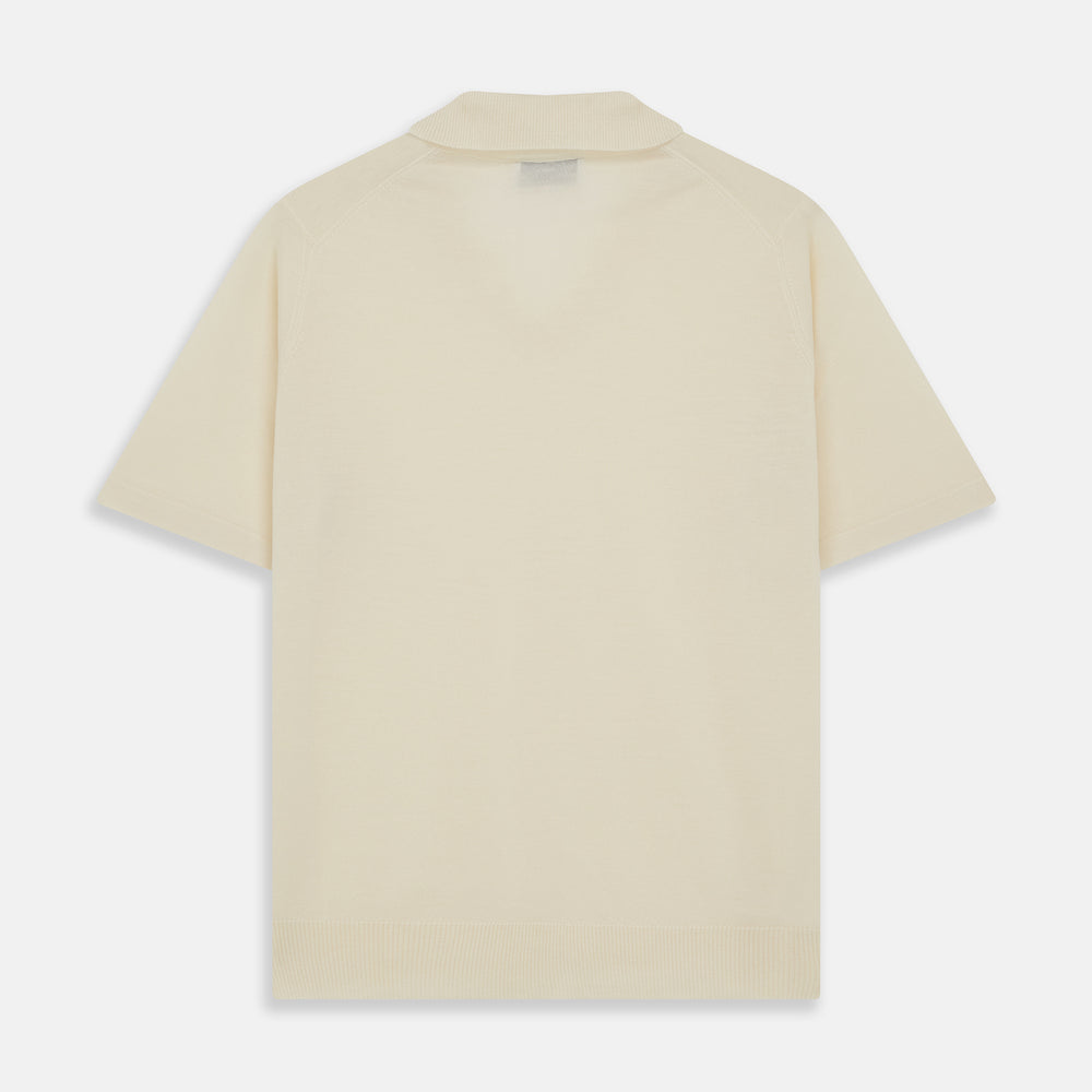 The Turnbull & Asser Ecru Merino Wool Roland Polo Shirt, made in Scotland, features soft merino wool, short sleeves, a relaxed open collar, and an inner neckline label. Shown here on a plain white background.