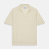 View 1 of product The Turnbull & Asser Ecru Merino Wool Roland Polo Shirt, made in Scotland, features soft merino wool, short sleeves, a relaxed open collar, and an inner neckline label. Shown here on a plain white background.
