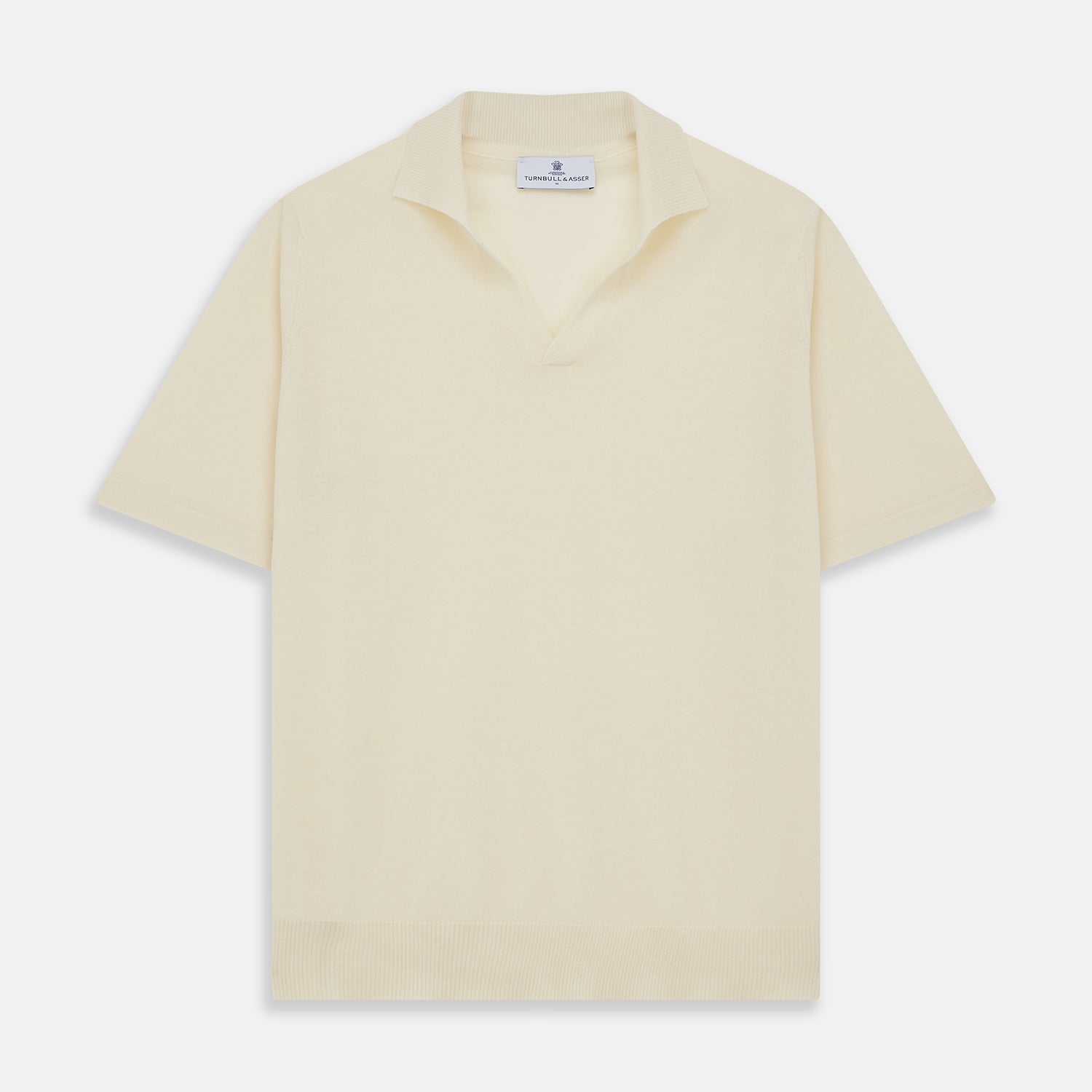 View 1 of product The Turnbull & Asser Ecru Merino Wool Roland Polo Shirt, made in Scotland, features soft merino wool, short sleeves, a relaxed open collar, and an inner neckline label. Shown here on a plain white background.