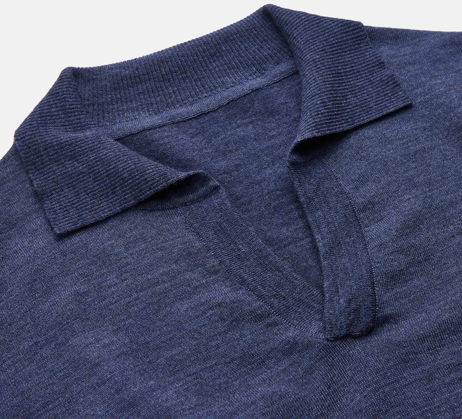 View 2 of product Turnbull & Asser Blue Merino Wool Roland Polo Shirt with short sleeves and an open collar, shown flat on a white background.