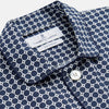 View 2 of product The Navy Motif Silk-Blend Hyde Pyjama Set by Turnbull & Asser features a blue and white pattern, long-sleeve button-up top with collar and front pocket, and matching pants, all displayed against a white background.