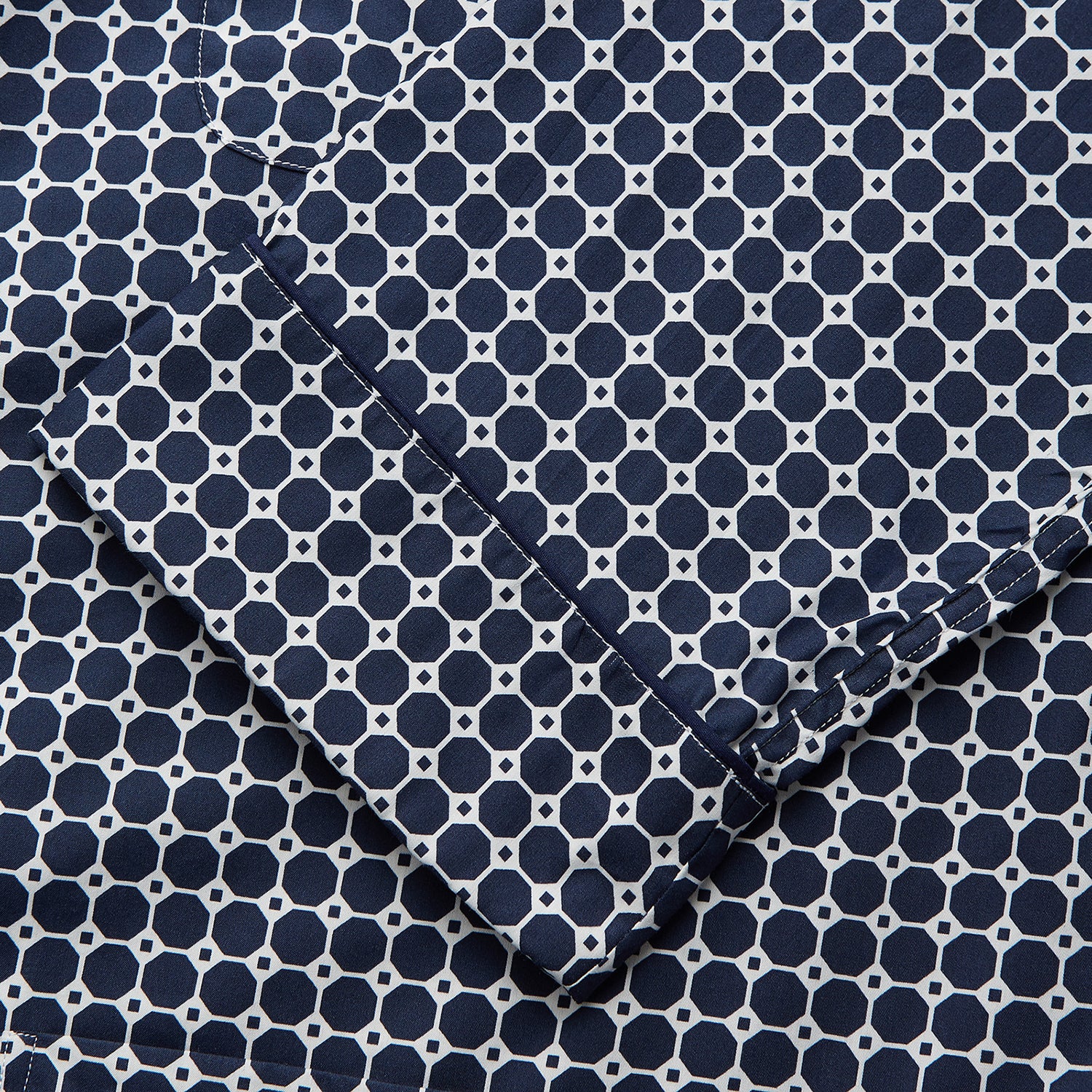 View 3 of product The Navy Motif Silk-Blend Hyde Pyjama Set by Turnbull & Asser features a blue and white pattern, long-sleeve button-up top with collar and front pocket, and matching pants, all displayed against a white background.