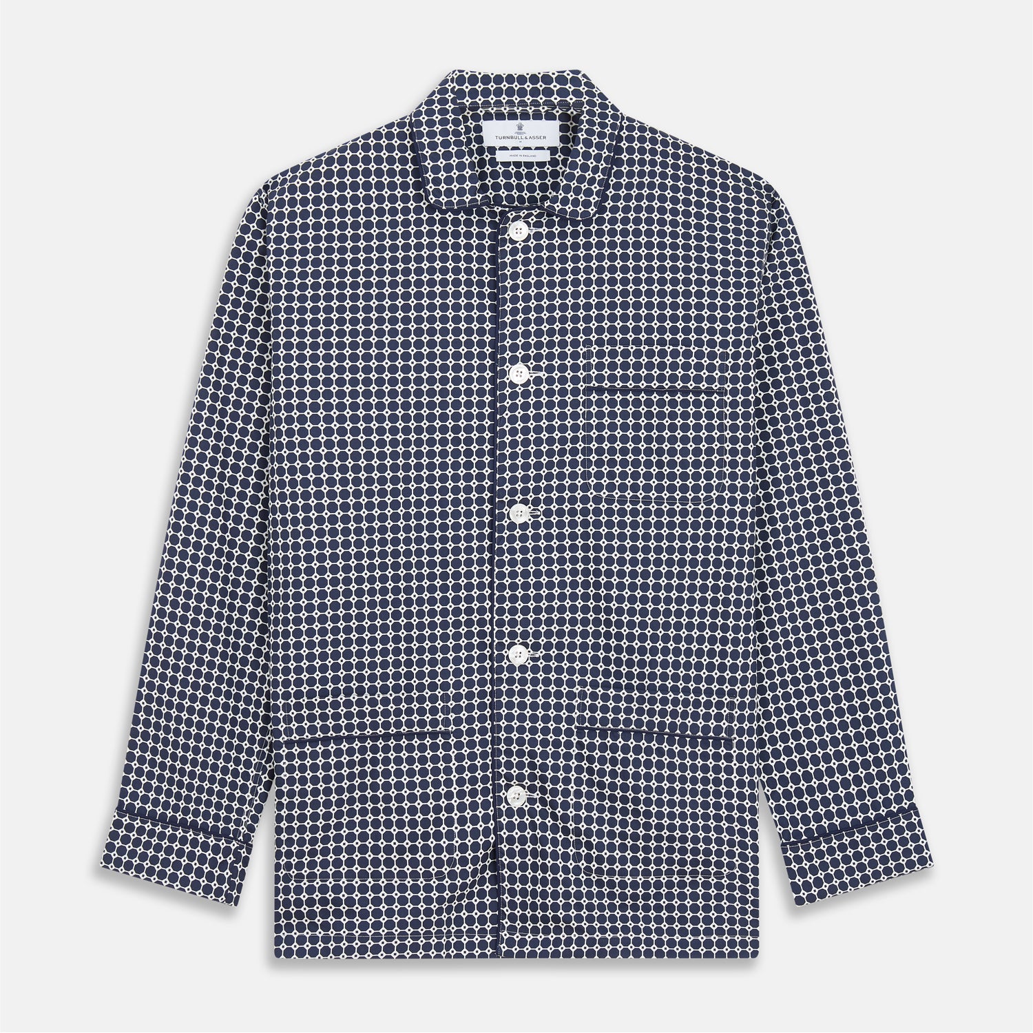 View 5 of product The Navy Motif Silk-Blend Hyde Pyjama Set by Turnbull & Asser features a blue and white pattern, long-sleeve button-up top with collar and front pocket, and matching pants, all displayed against a white background.