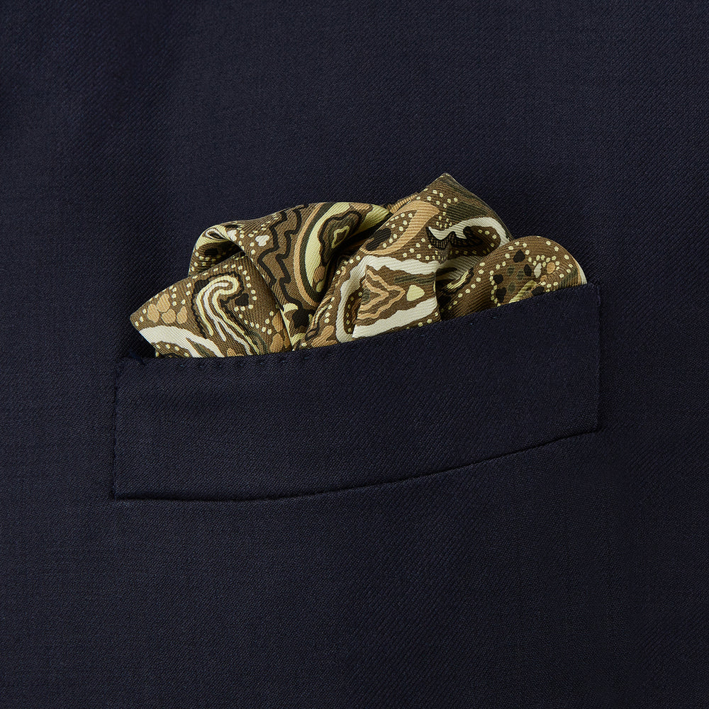 A green and lemon silk pocket square featuring a blossoming paisley pattern with a solid edge. “Turnbull & Asser” is inscribed in one corner; expertly crafted in England.