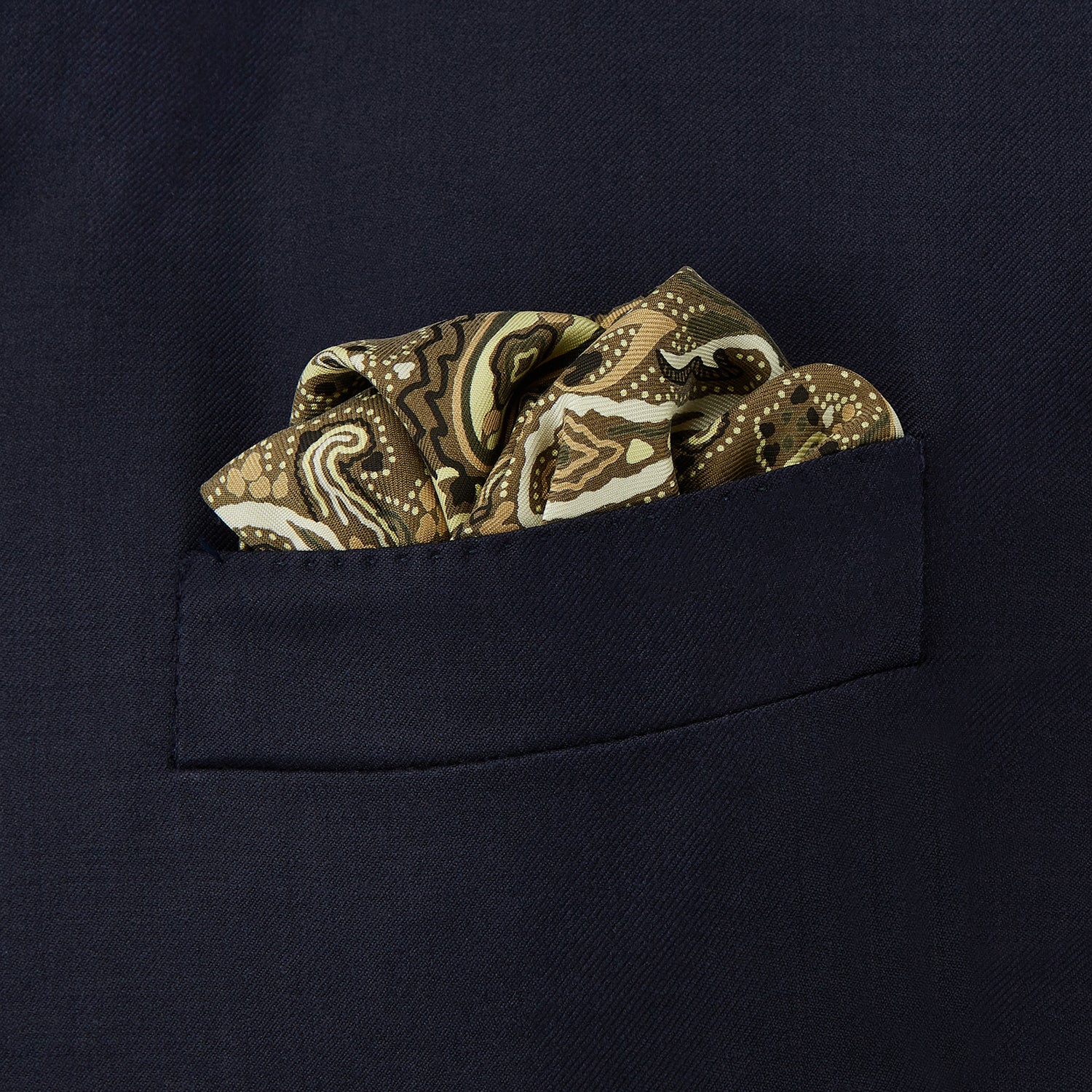View 3 of product A green and lemon silk pocket square featuring a blossoming paisley pattern with a solid edge. “Turnbull & Asser” is inscribed in one corner; expertly crafted in England.