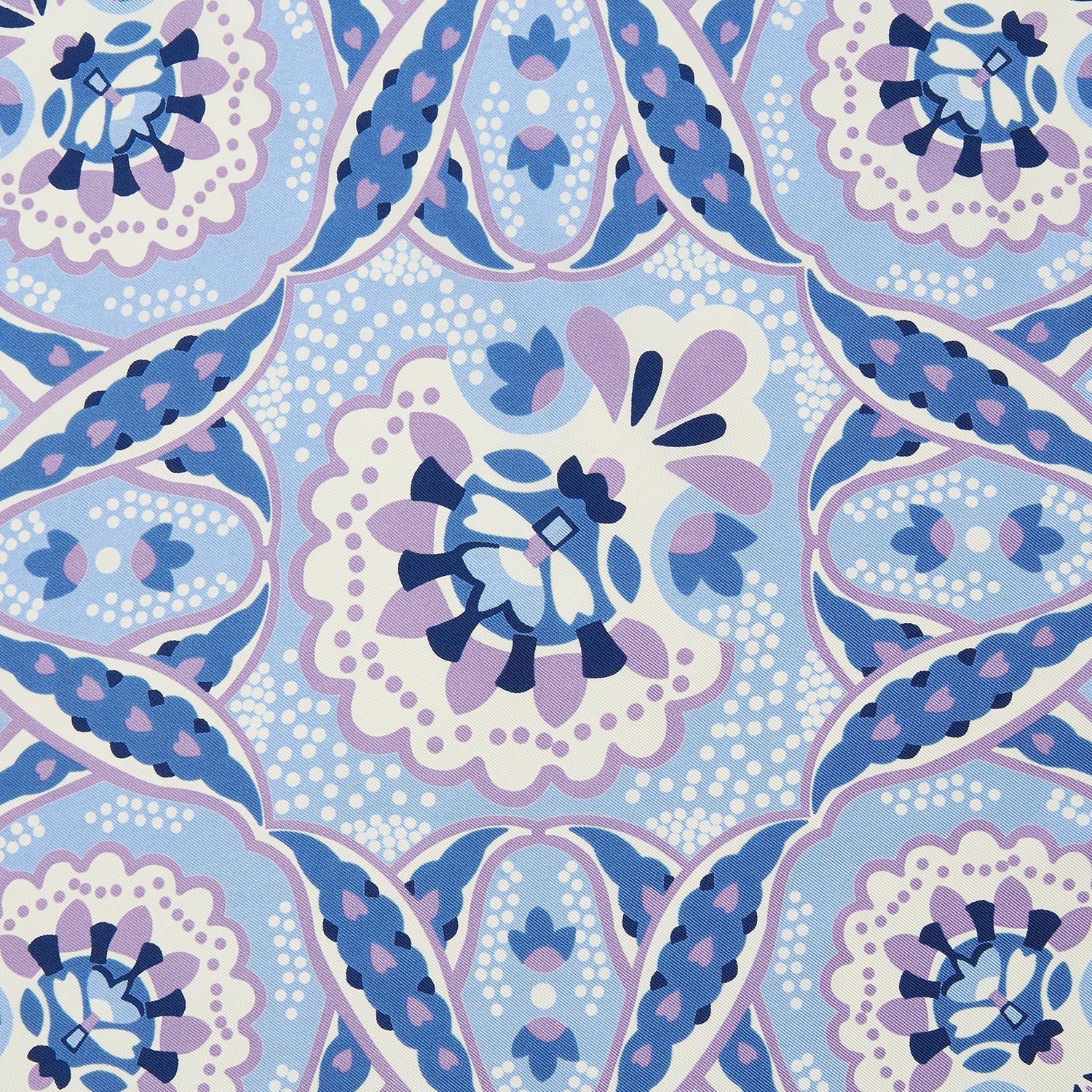 View 3 of product The Pale Blue and Lilac Baroque Silk Pocket Square by Turnbull & Asser features intricate geometric and floral patterns in blue, lilac, and white with a floral border and the brand name printed in one corner.