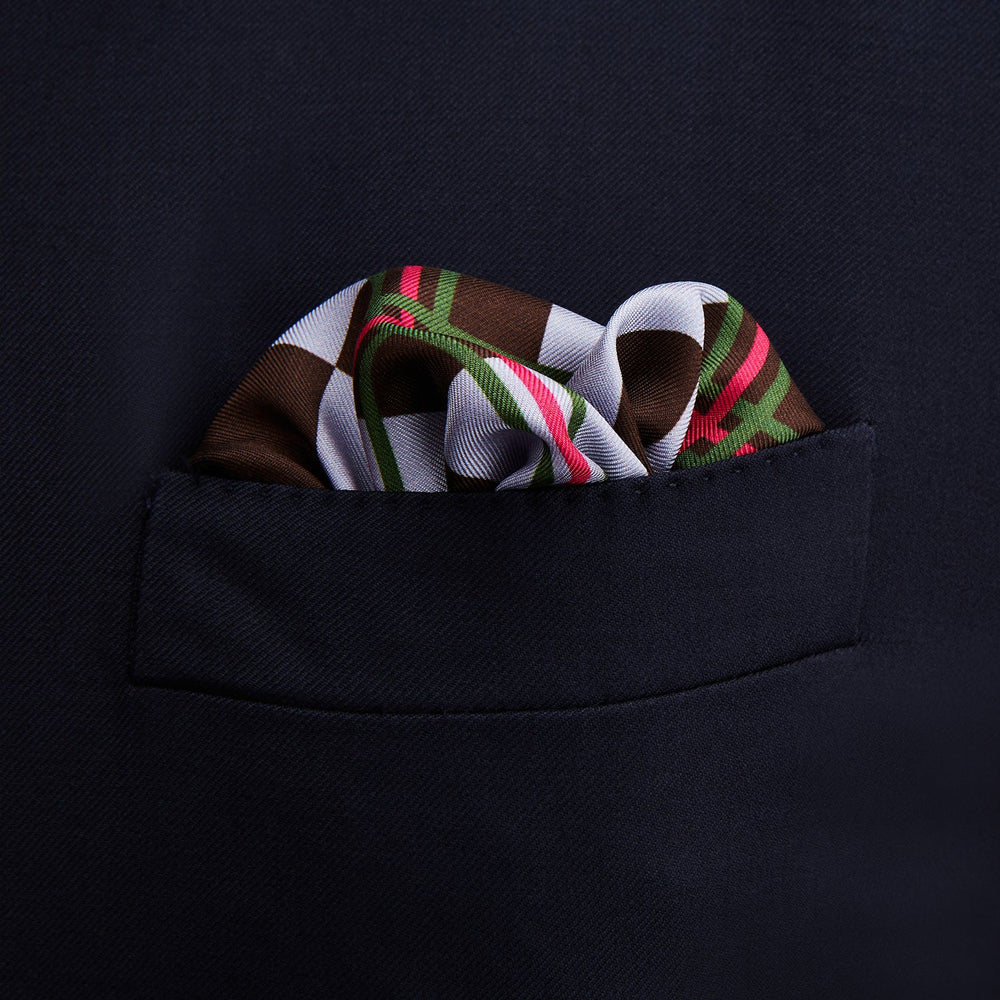 The Turnbull & Asser Green and Red Checked Chess Board Silk Pocket Square features brown, green, red, and white stripes with a thin green border and the brand's name in the bottom right corner.