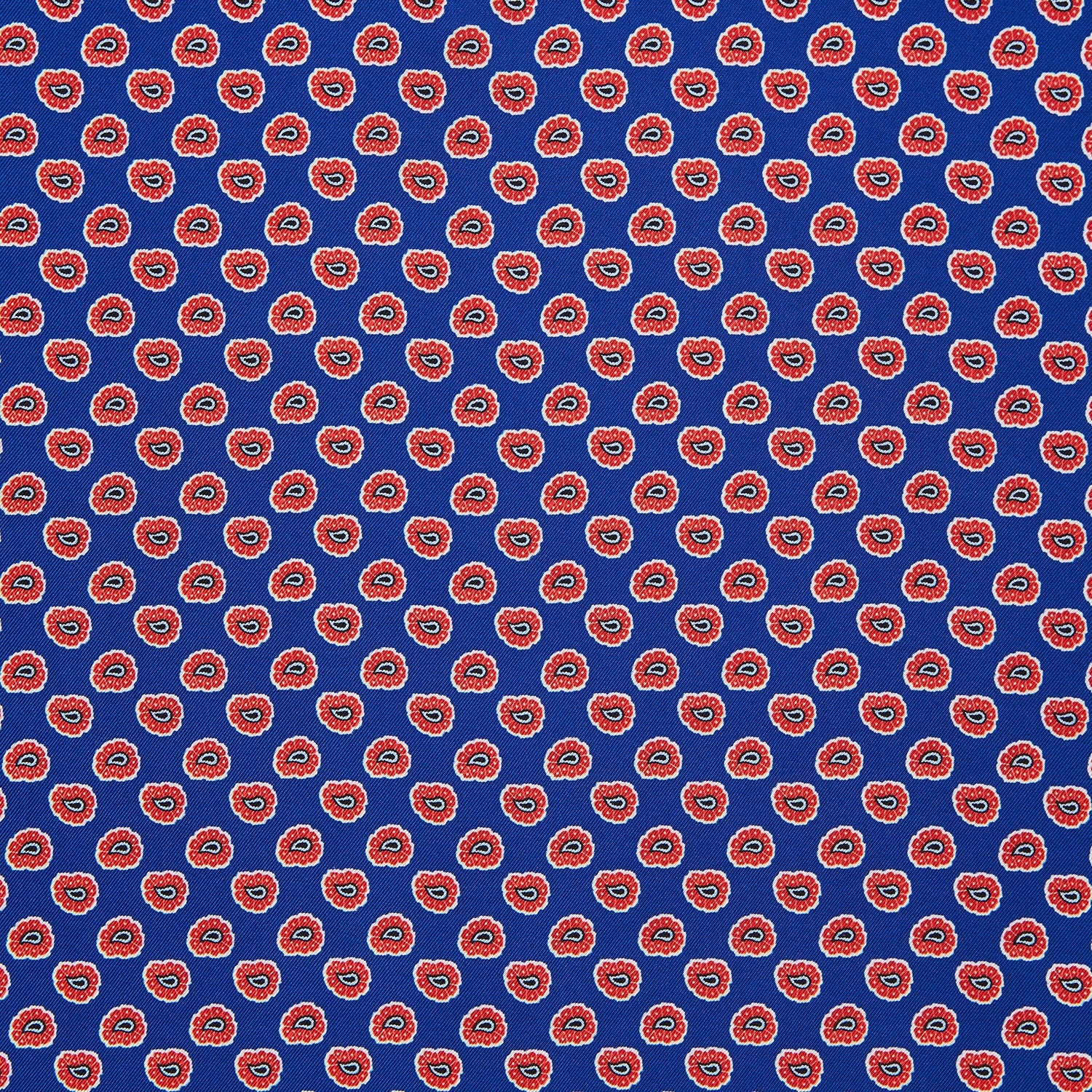 View 2 of product The Blue and Red Paisley Tiles Silk Pocket Square by Turnbull & Asser features a blue background, red and white paisley border, central repeating circular patterns, and “Turnbull & Asser” in one corner. Made in England.