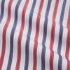 View 2 of product The Turnbull & Asser Red and Blue Stripe Cotton Regular Fit Whitby Shirt is a long-sleeve button-up featuring vibrant red and blue stripes on white, with a collar and buttoned cuffs, shown on a plain white surface.