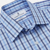 View 2 of product The Turnbull & Asser Light Blue and Navy Check Cotton Regular Fit Mayfair Shirt features a T&A collar and button-up long sleeves, displayed laid flat on a white background.
