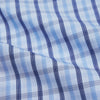 View 4 of product The Turnbull & Asser Light Blue and Navy Check Cotton Regular Fit Mayfair Shirt features a T&A collar and button-up long sleeves, displayed laid flat on a white background.