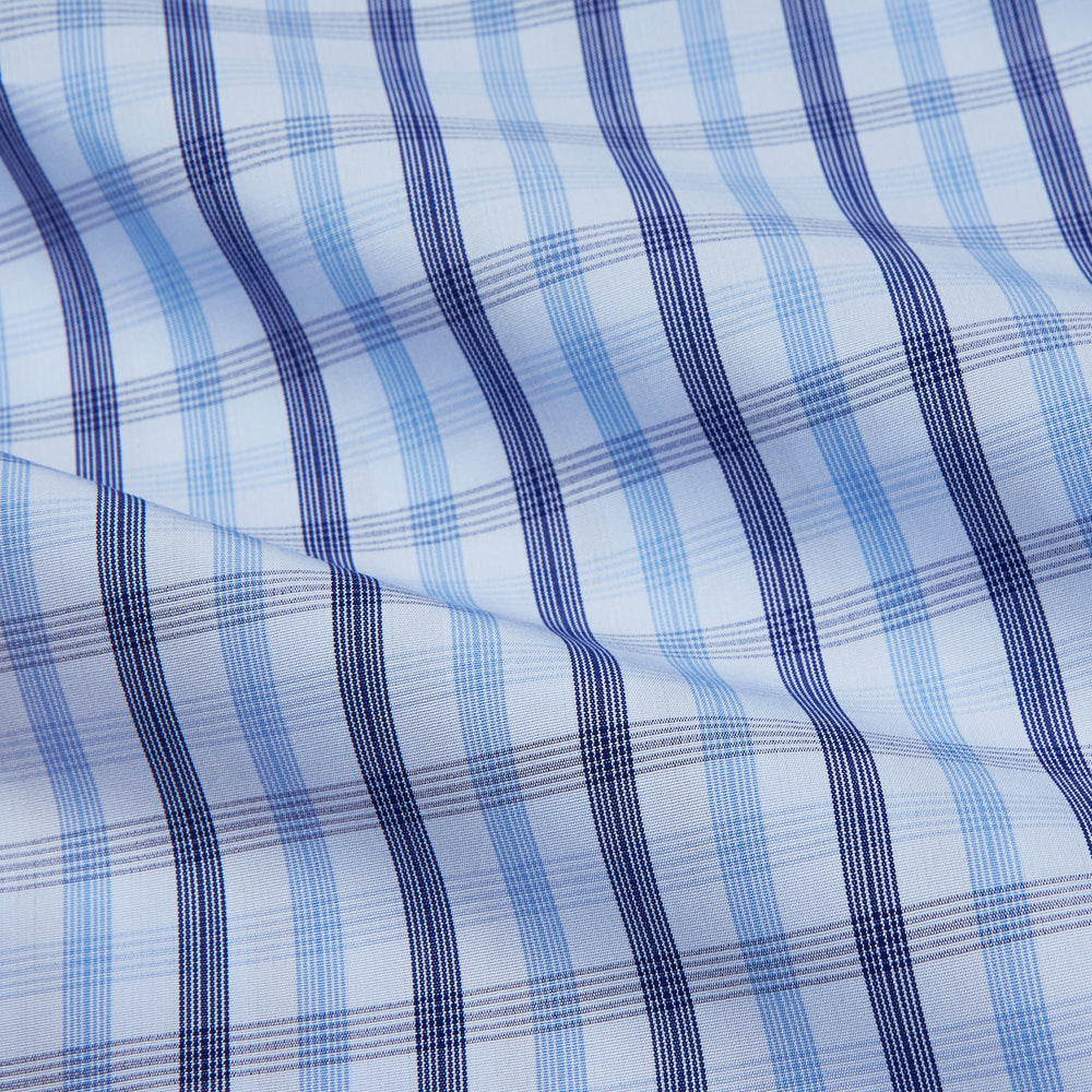 The Turnbull & Asser Light Blue and Navy Check Cotton Regular Fit Mayfair Shirt features a T&A collar and button-up long sleeves, displayed laid flat on a white background.
