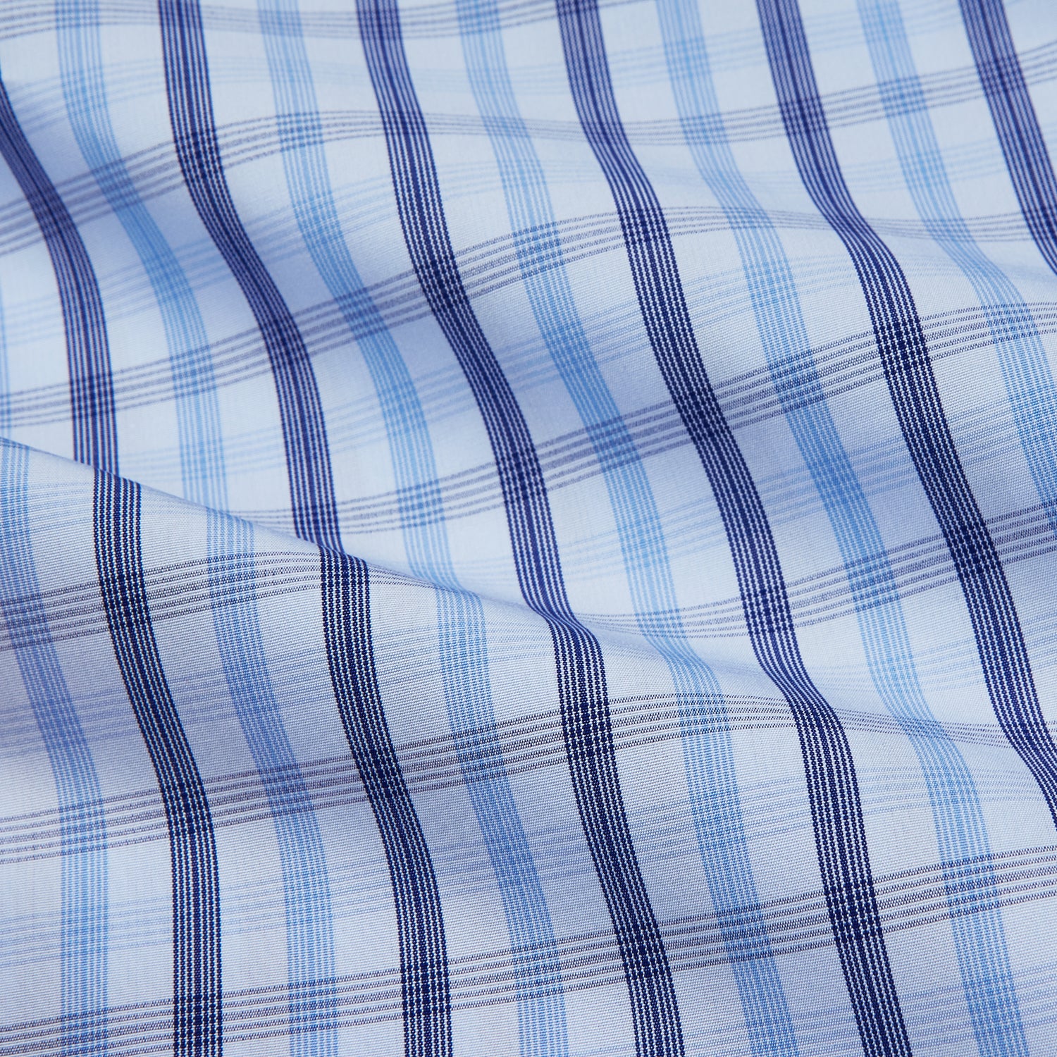 View 4 of product The Turnbull & Asser Light Blue and Navy Check Cotton Regular Fit Mayfair Shirt features a T&A collar and button-up long sleeves, displayed laid flat on a white background.