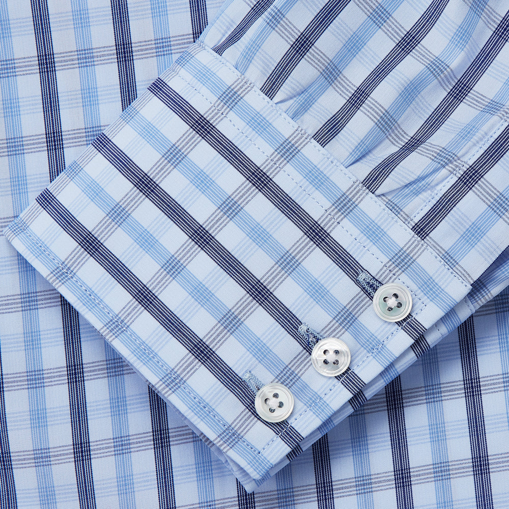 The Turnbull & Asser Light Blue and Navy Check Cotton Regular Fit Mayfair Shirt features a T&A collar and button-up long sleeves, displayed laid flat on a white background.