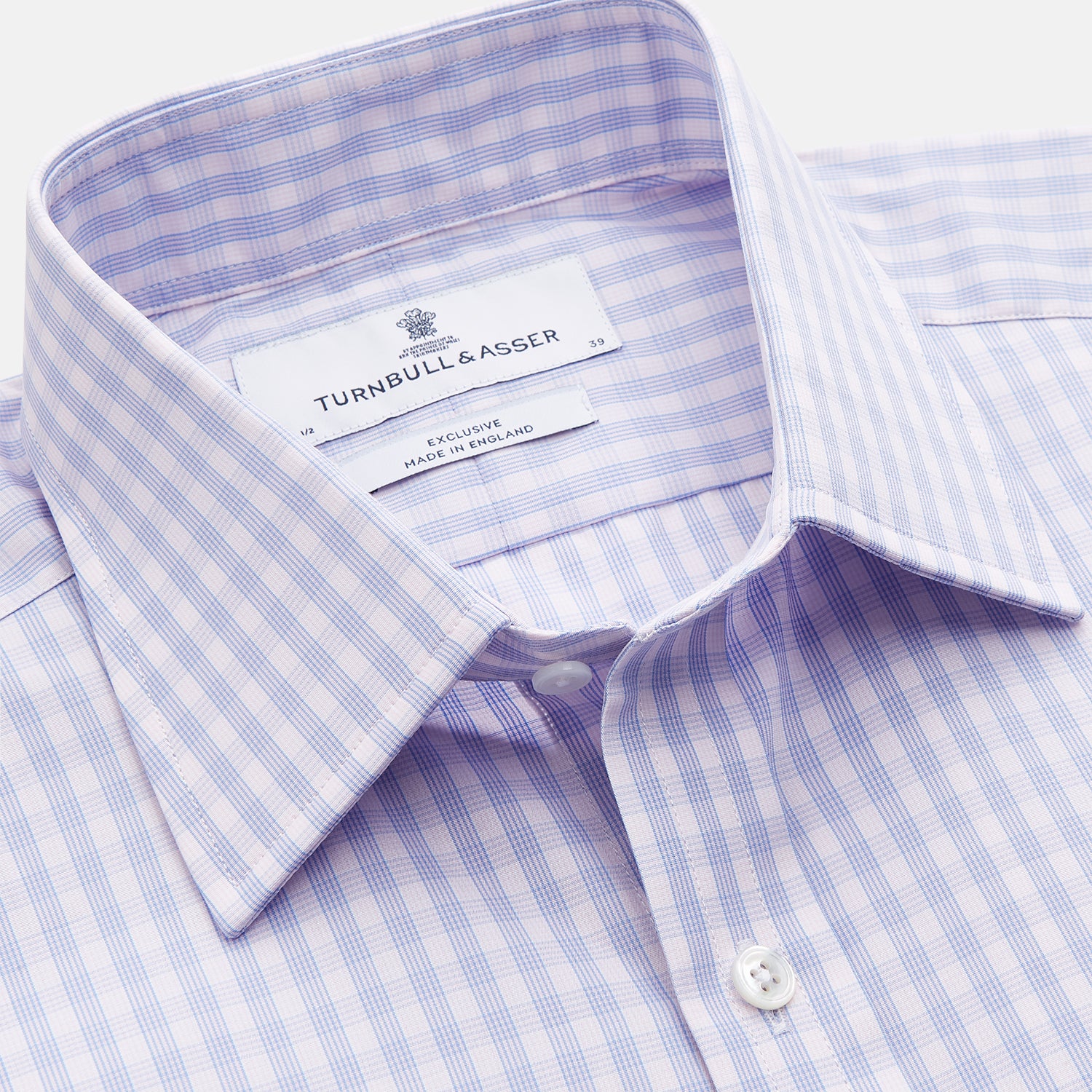 View 2 of product The Turnbull & Asser Lilac Multi Check Cotton Regular Fit Mayfair Shirt features a classic T&A collar and button-up design, shown laid flat in a light purple gingham pattern.
