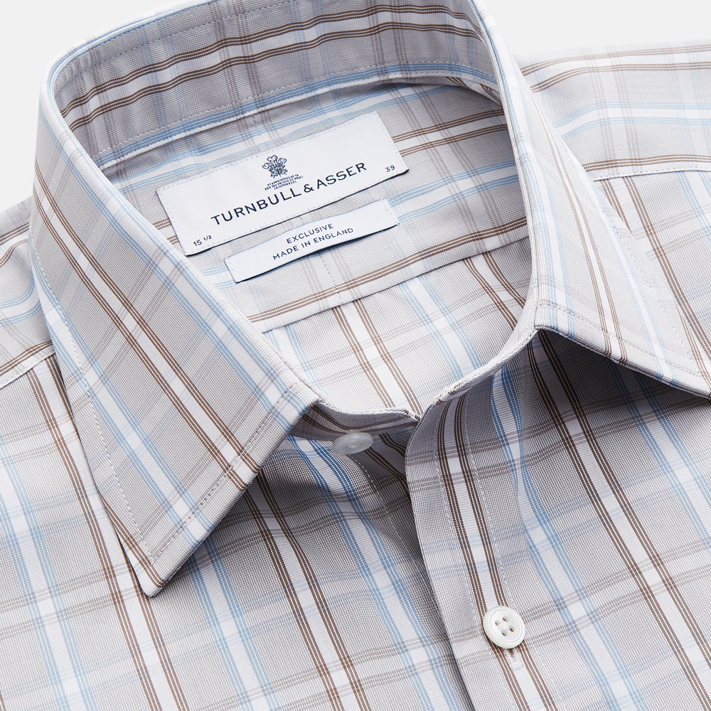 The Beige and Light Blue Check Cotton Regular Fit Mayfair Shirt by Turnbull & Asser features a classic plaid pattern, T&A collar, cuffed sleeves, and button-up front, shown laid flat on a white background.