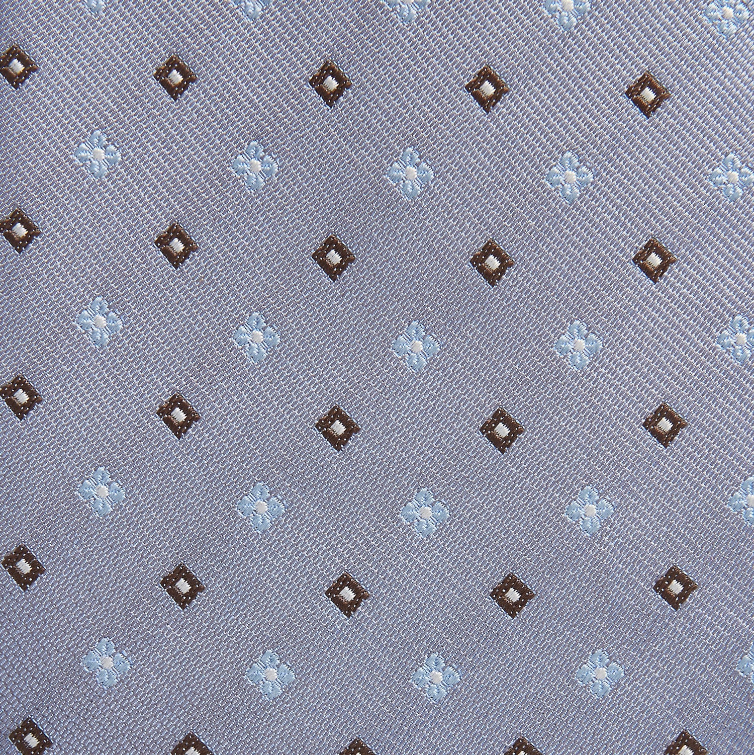View 2 of product The Pale Blue Multi Floret Silk Tie by Turnbull & Asser features light purple silk with a pale blue floret pattern and small brown squares—perfect for pairing with a classic Turnbull & Asser shirt.
