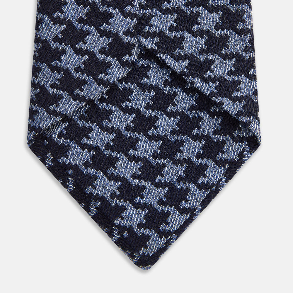 The Turnbull & Asser Navy and Blue Houndstooth Wool Blend Tie features a stylish houndstooth pattern in navy and light blue.
