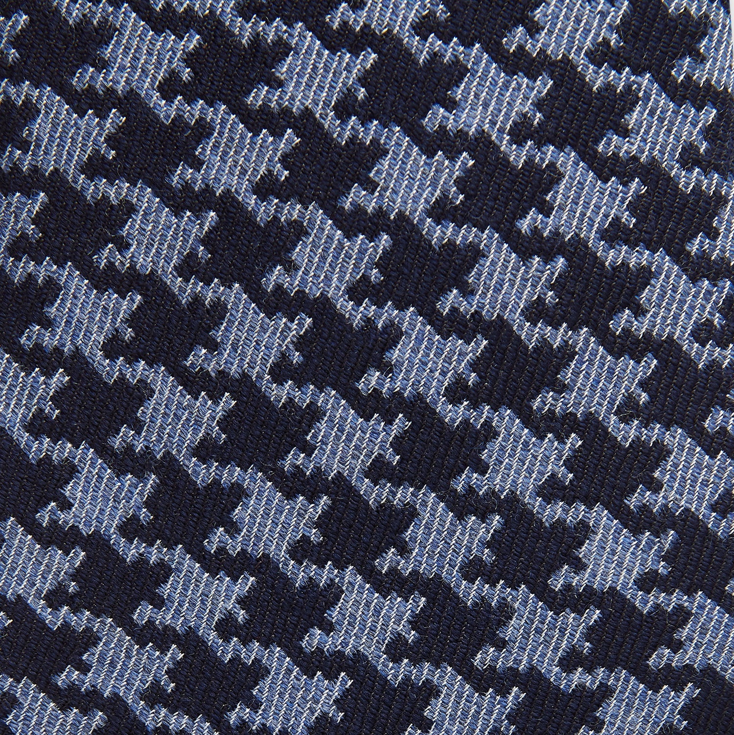 View 2 of product The Turnbull & Asser Navy and Blue Houndstooth Wool Blend Tie features a stylish houndstooth pattern in navy and light blue.