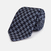 View 1 of product The Turnbull & Asser Navy and Blue Houndstooth Wool Blend Tie features a stylish houndstooth pattern in navy and light blue.