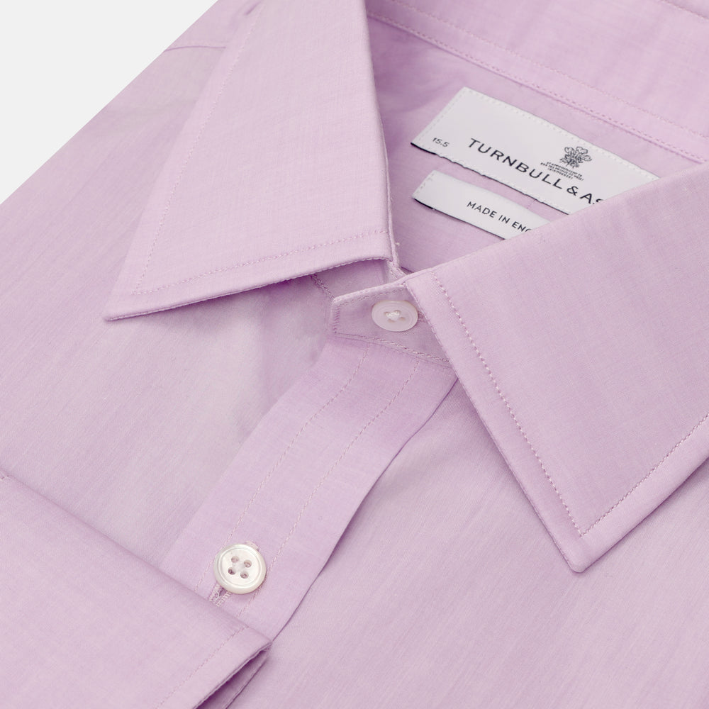 The Turnbull & Asser LILAC COTTON REGULAR FIT SHIRT is a long-sleeve, button-up cotton shirt with white buttons, a classic T&A collar, and cuffs, shown laid flat on a white background.
