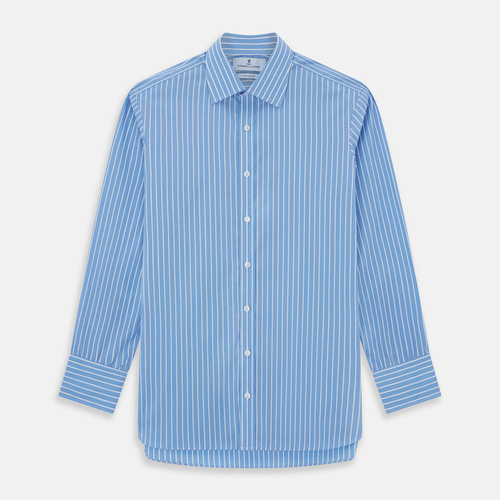 The Turnbull & Asser BLUE & WHITE STRIPE COTTON REGULAR FIT SHIRT features long sleeves, a pointed collar, and vertical white stripes on a light blue background, displayed against a plain white surface.