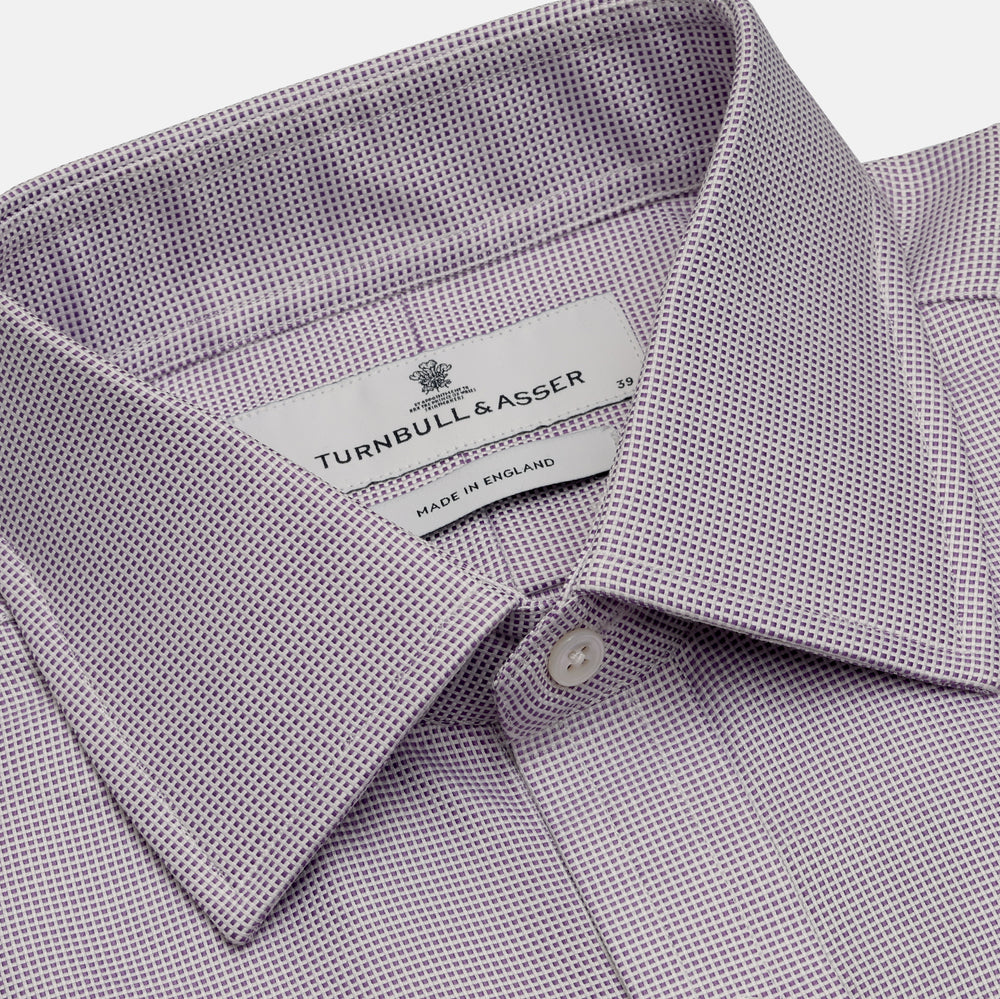 The Turnbull & Asser LILAC MULTI-CHECK COTTON REGULAR FIT SHIRT features long sleeves, a pointed collar, and white buttons—an essential men's wardrobe piece, shown laid flat on a white background.