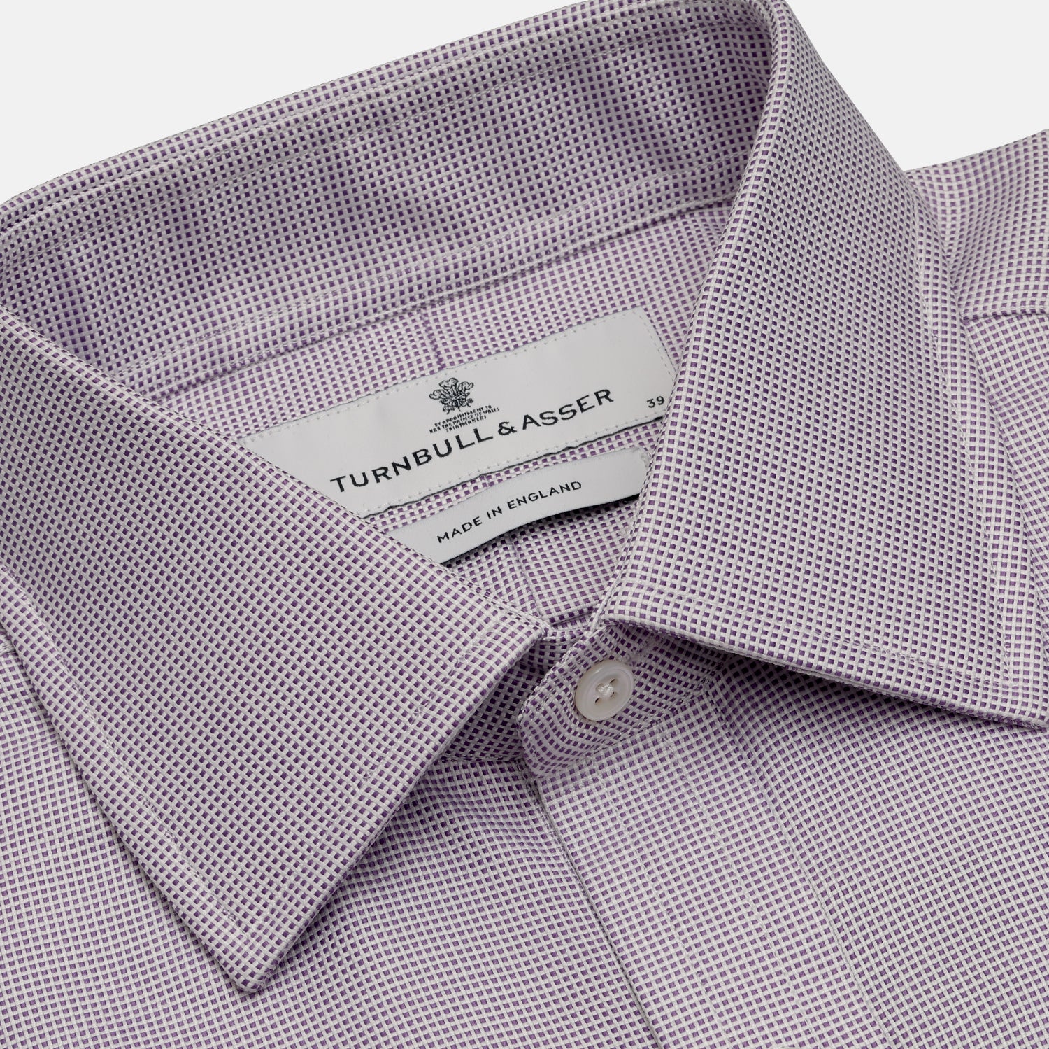 View 2 of product The Turnbull & Asser LILAC MULTI-CHECK COTTON REGULAR FIT SHIRT features long sleeves, a pointed collar, and white buttons—an essential men's wardrobe piece, shown laid flat on a white background.