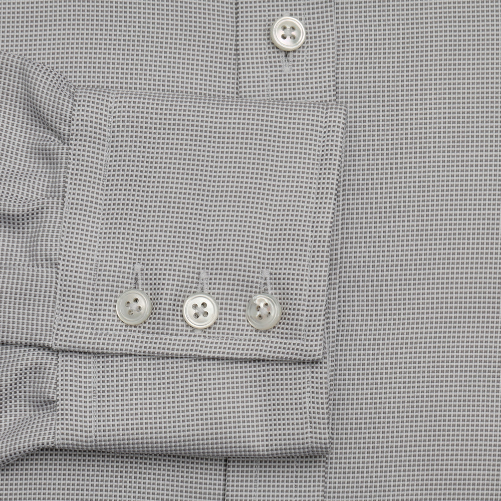 The Turnbull & Asser Silver Multi-Check Cotton Regular Fit Shirt features light gray cotton, a classic collar, buttoned cuffs, and a subtle silver check pattern—an essential for any men's wardrobe, shown flat on a white background.