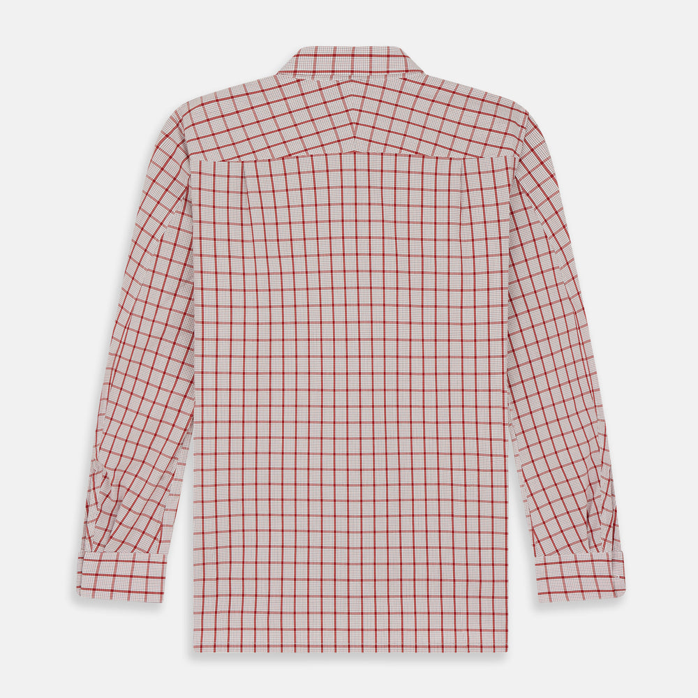 The Turnbull & Asser Red Graph Overlay Check Piccadilly Shirt is a cotton, long-sleeve button-up with a white base, red graph check pattern, collar, two chest flap pockets, and white buttons on the front and cuffs.