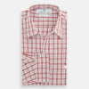 View 5 of product The Turnbull & Asser Red Graph Overlay Check Piccadilly Shirt is a cotton, long-sleeve button-up with a white base, red graph check pattern, collar, two chest flap pockets, and white buttons on the front and cuffs.